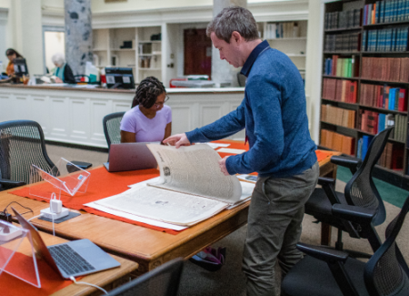 Researches examine collection items in the reading room.