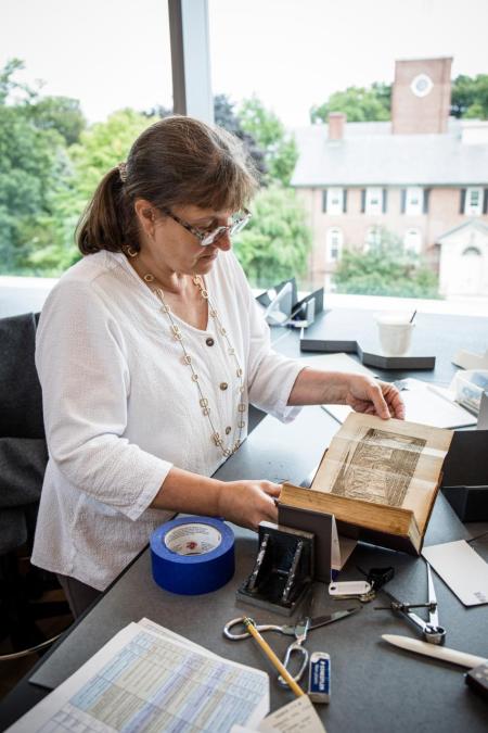 Conservator working on a book