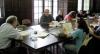 Kevin Sweeney seated at conference table with seated students.